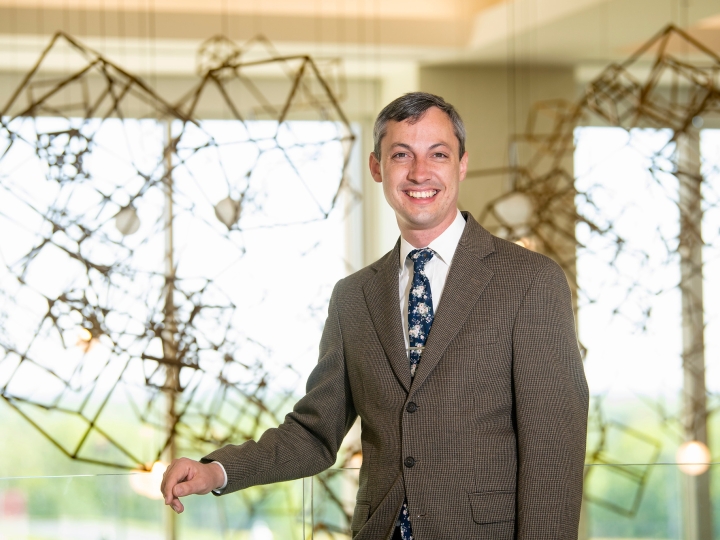Daniel Street wears a brown suit and smiles